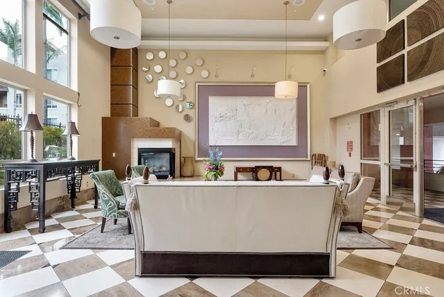 a living room with furniture a fireplace and a dining table