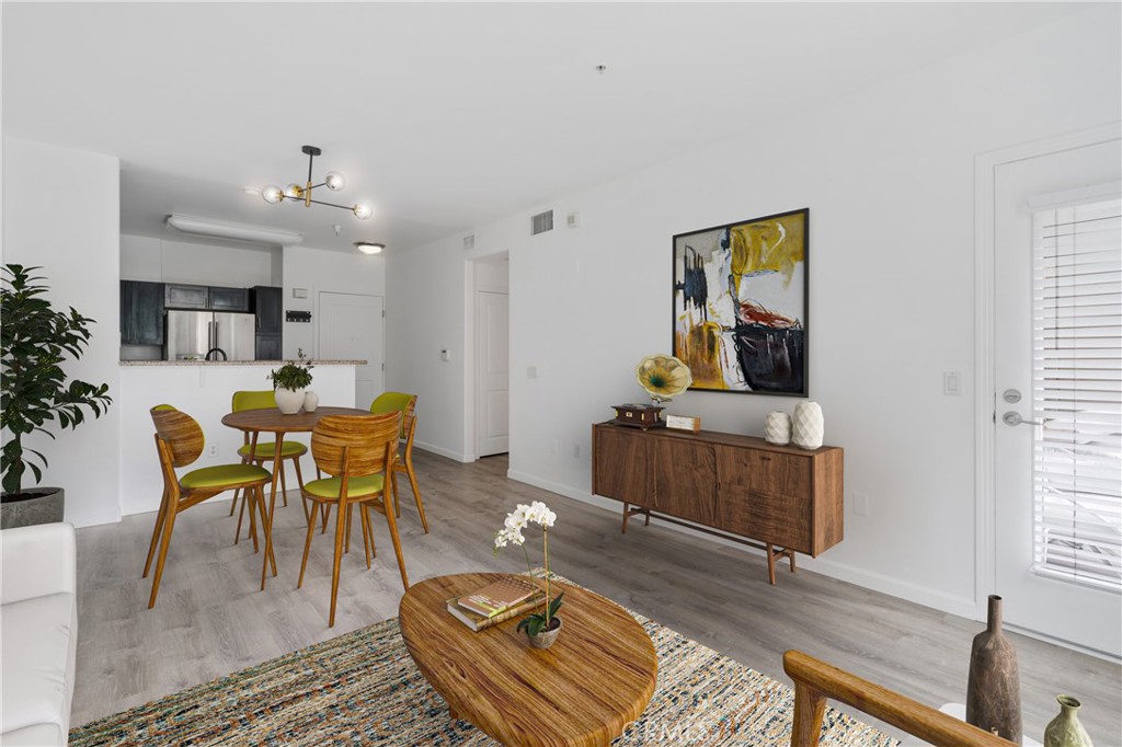 100 South Alameda Street, Unit 213 Los Angeles, CA 90012 - Photo 4 of 41 a living room with furniture and wooden floor