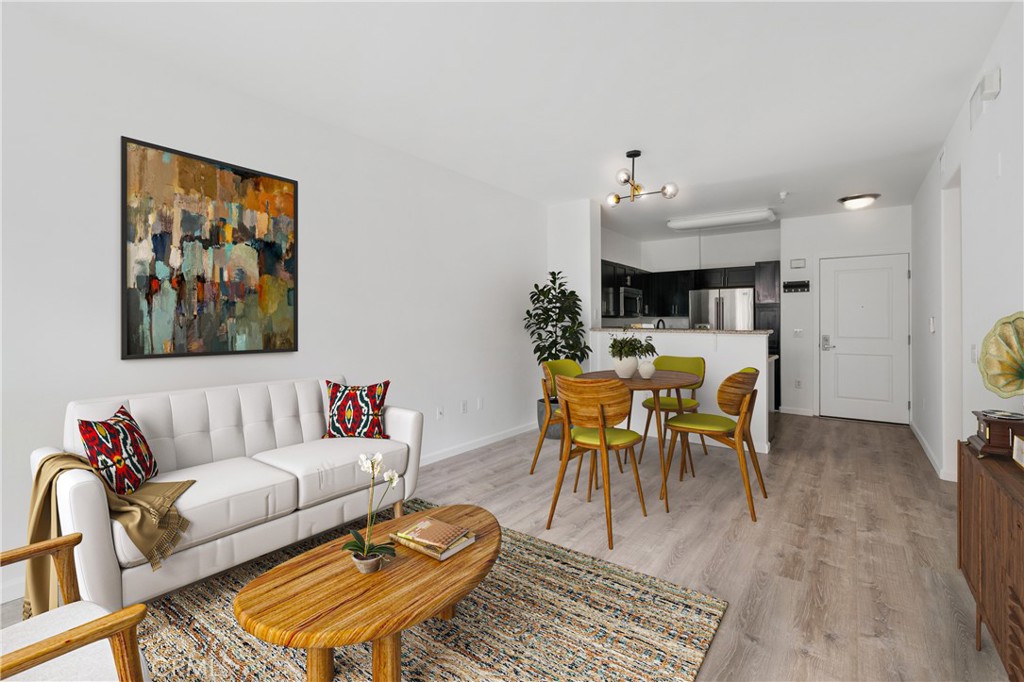 100 South Alameda Street, Unit 213 Los Angeles, CA 90012 - Photo 5 of 41 a living room with furniture a dining table and paintings on the wall
