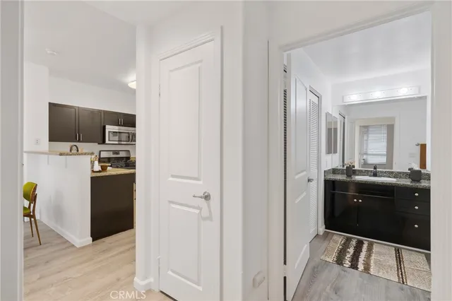 a kitchen with a refrigerator and a stove top oven