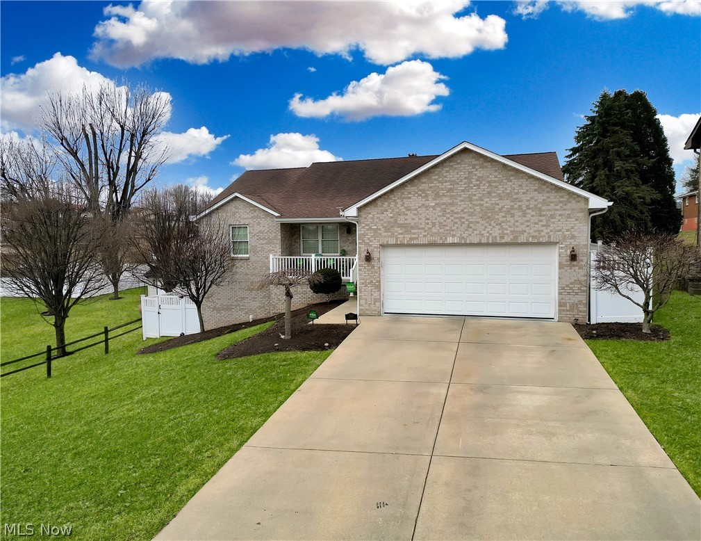 1343 Courtland Road Weirton, WV 26062 - Photo 2 of 50 Single story home featuring an attached garage, concrete driveway, brick siding, and a porch