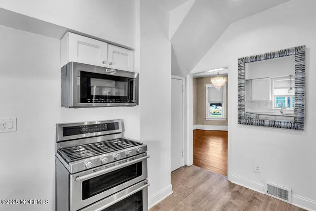 a kitchen with a stove and a microwave