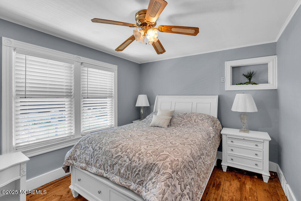 708 18th Avenue Lake Como, NJ 07719 - Photo 17 of 35 a bedroom with a bed and a chandelier