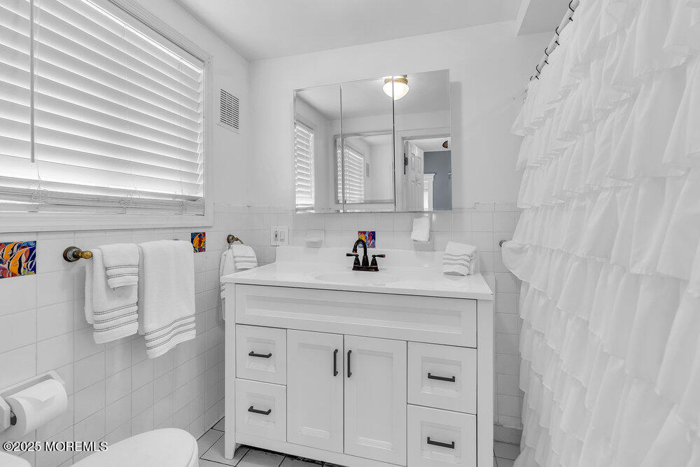 708 18th Avenue Lake Como, NJ 07719 - Photo 6 of 35 a bathroom with a sink vanity and a mirror