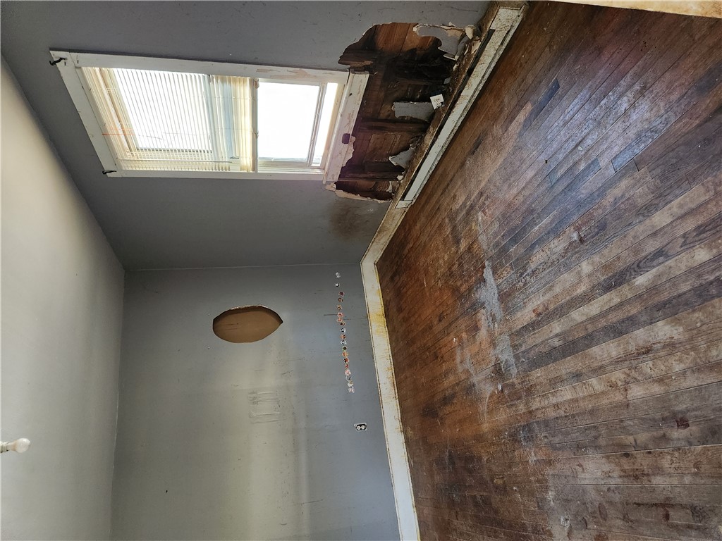 1326 Chiquola Avenue Honea Path, SC 29654 - Photo 13 of 15 This interior offers a canvas for renovation, featuring rustic wood flooring and a bright skylight.