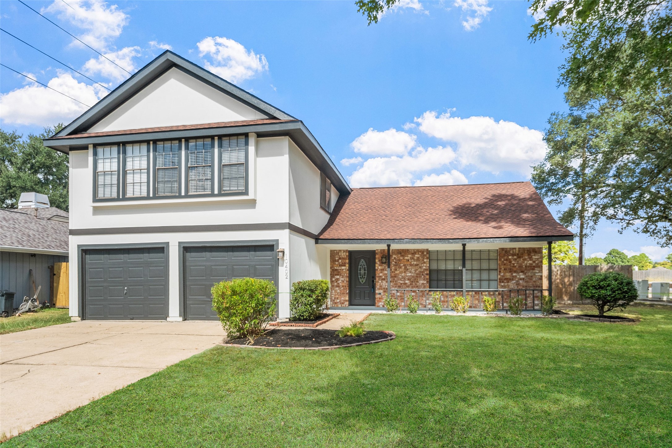 10402 Trading Post Drive Houston, TX 77064 - Photo 1 of 43 a front view of a house with a yard and garage