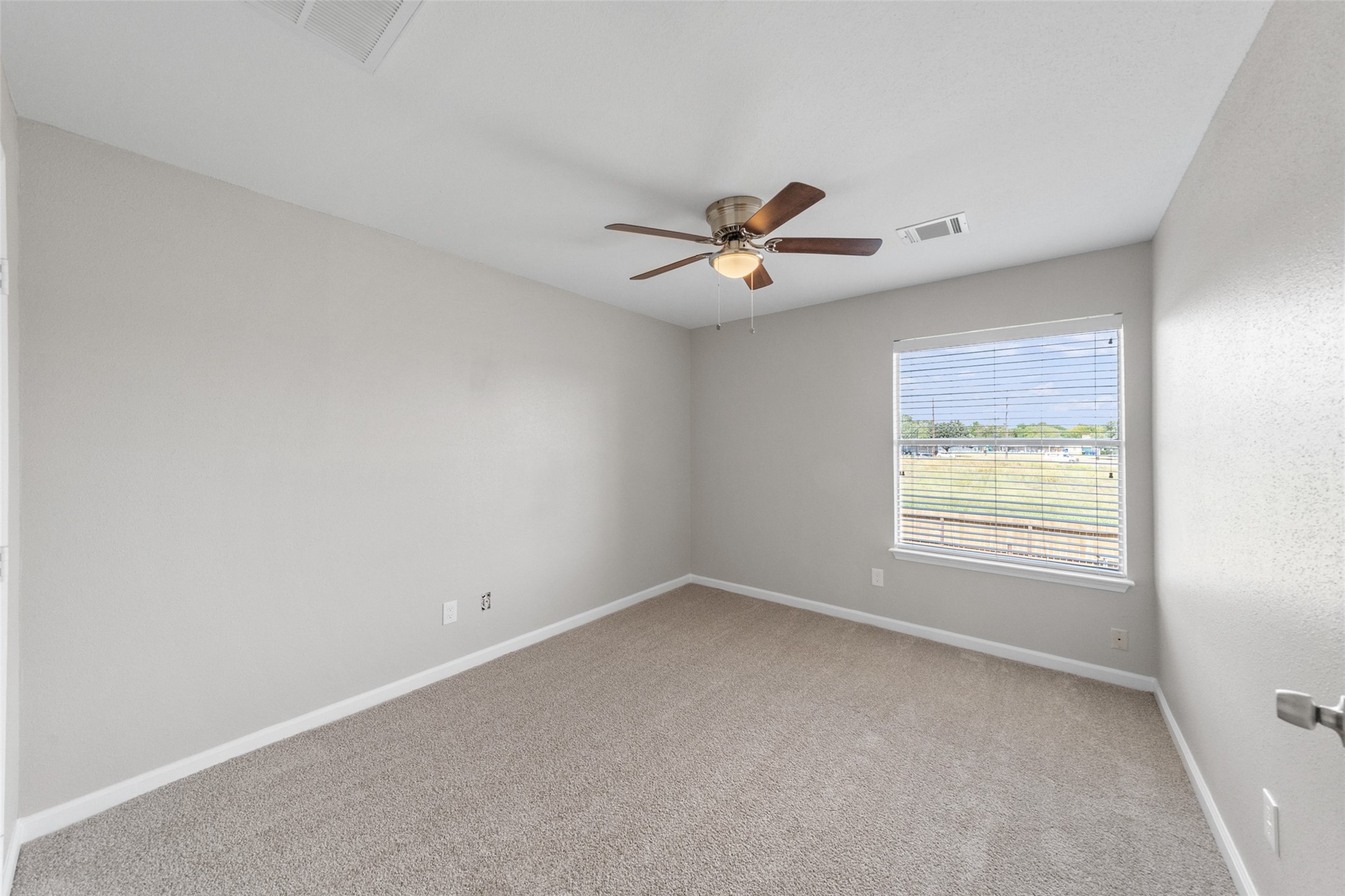 10402 Trading Post Drive Houston, TX 77064 - Photo 17 of 43 an empty room with a window and a ceiling fan