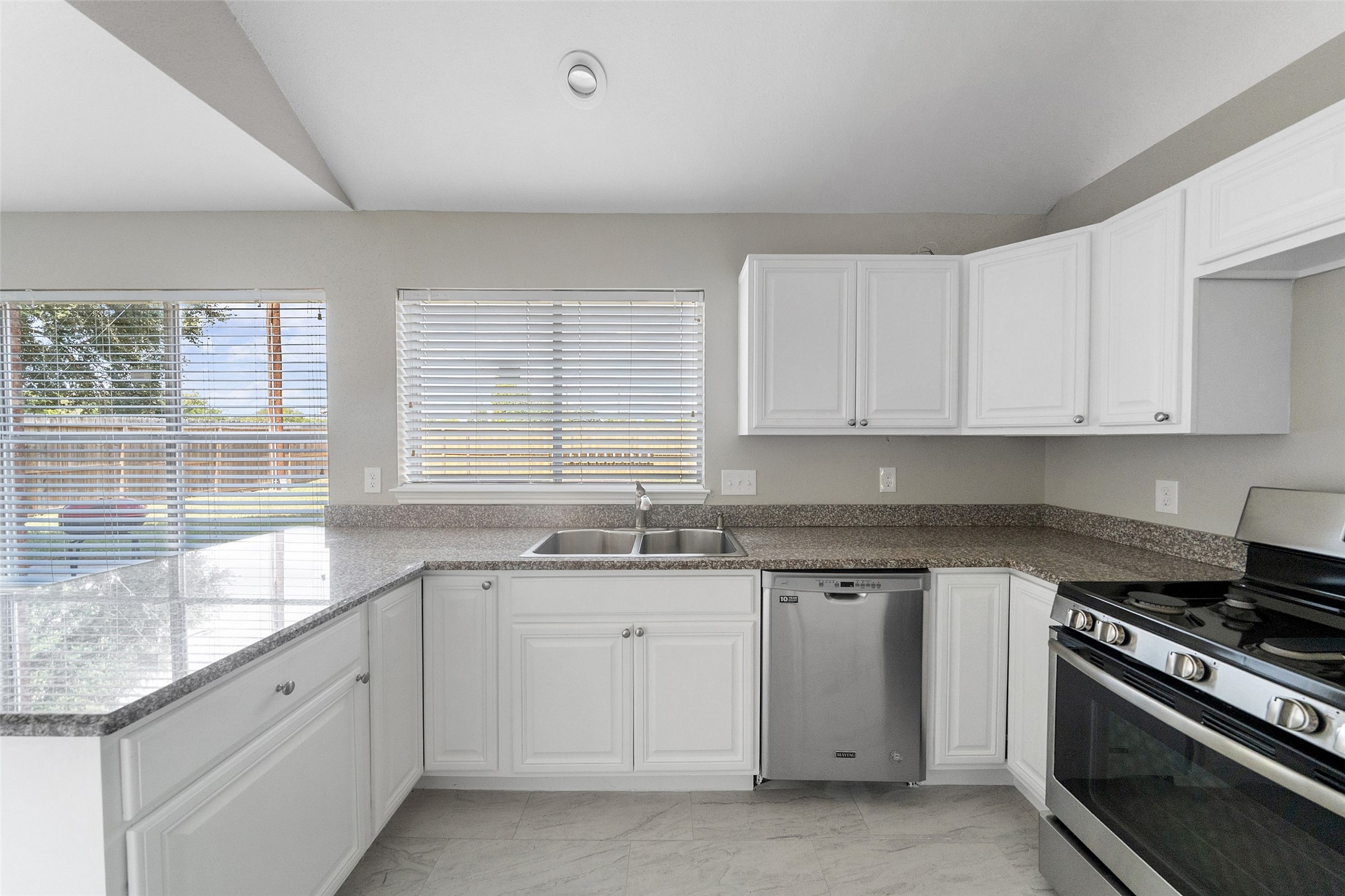 10402 Trading Post Drive Houston, TX 77064 - Photo 10 of 43 a kitchen with granite countertop white cabinets and a sink