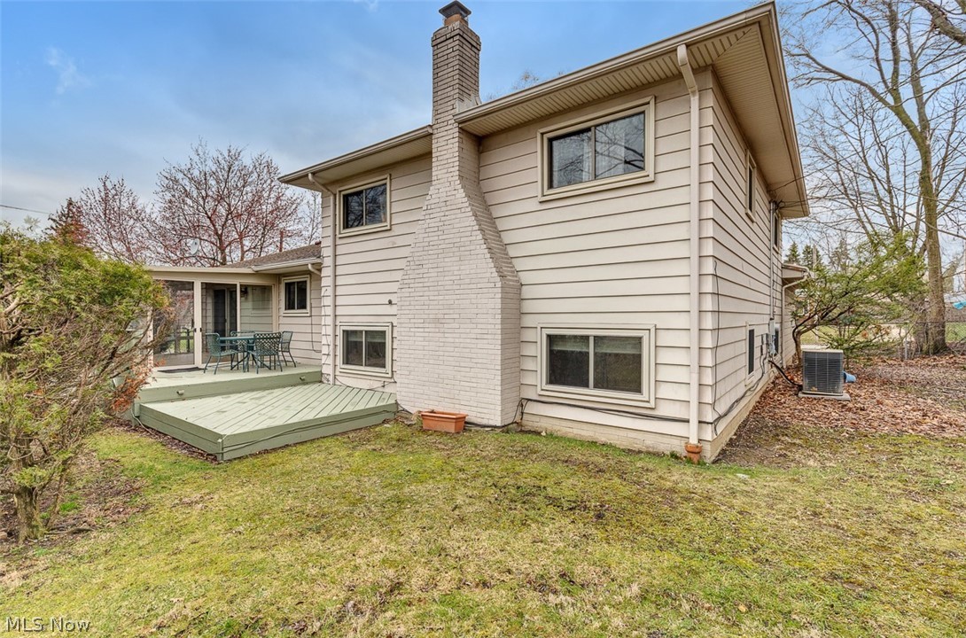 2990 Hampton Road Cleveland, OH 44120 - Photo 2 of 29 Rear view of house featuring a chimney, a yard, and a wooden deck