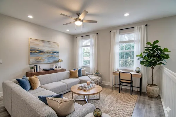 a living room with furniture and a large window