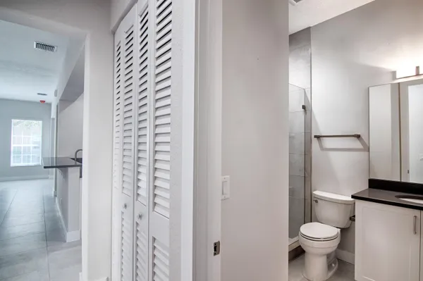 a white toilet sitting next to a bathroom sink