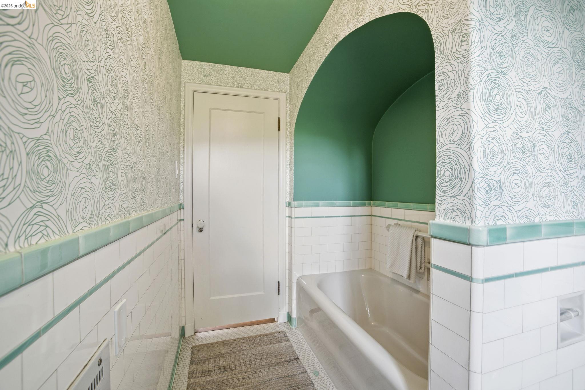 1087 Hubert Road Oakland, CA 94610 - Photo 52 of 67 Bathroom featuring a built-in bathtub within an arched alcove
