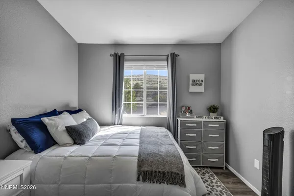 a bedroom with a bed and flat screen tv