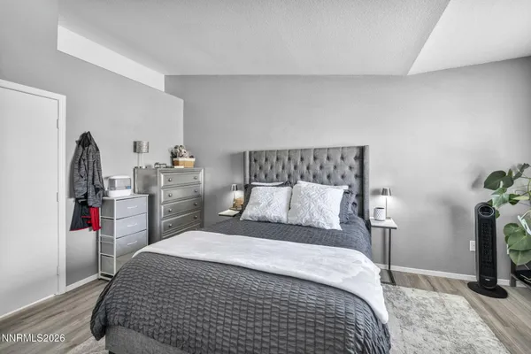 a bed room with a bed a television and a large window