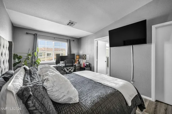 a bedroom with a bed and a television