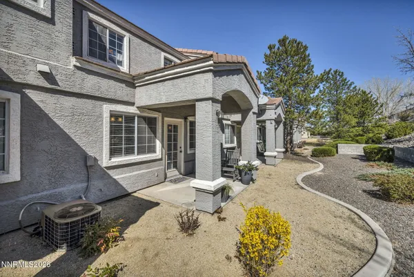 a front view of a house with outdoor seating