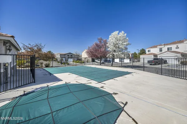 a view of a building with a yard and sitting area