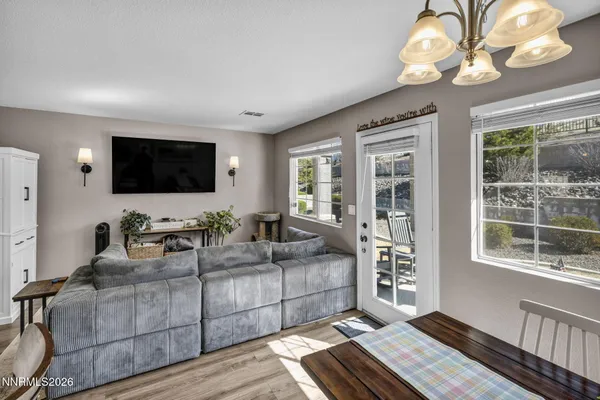 a living room with furniture a flat screen tv and a large window