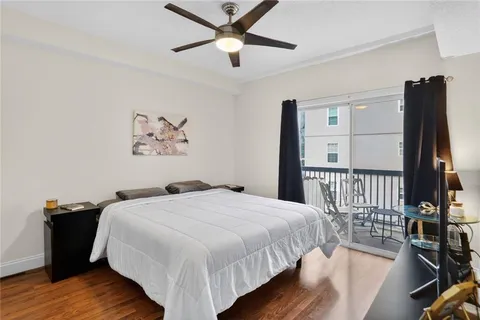 a bedroom with bed and wooden floor