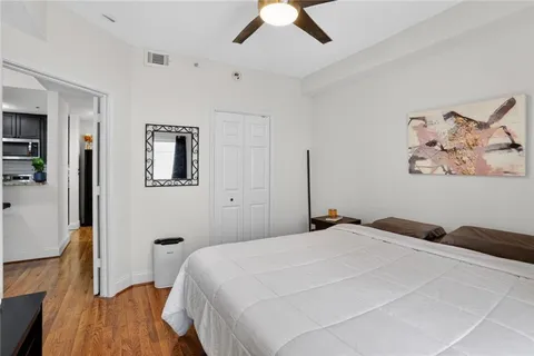 a bedroom with a bed and a wooden floor