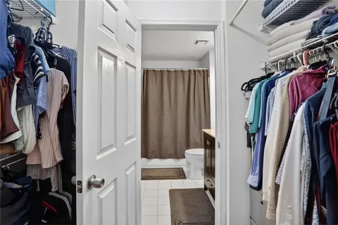 a view of walk in closet with clothes
