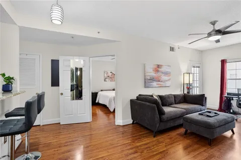 a living room with furniture and a wooden floor