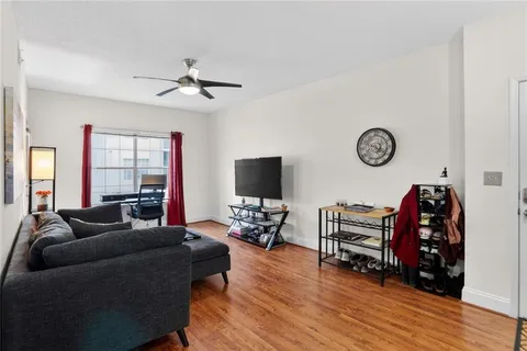 a living room with furniture and wooden floor