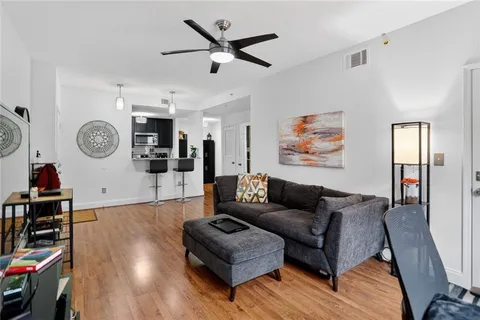 a living room with furniture and wooden floor