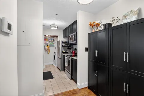 a kitchen with stainless steel appliances a refrigerator and a counter top space