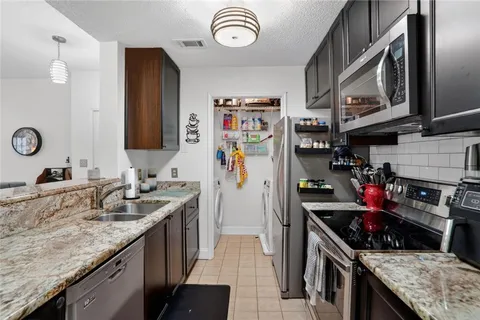 a kitchen with stainless steel appliances granite countertop a stove and a sink