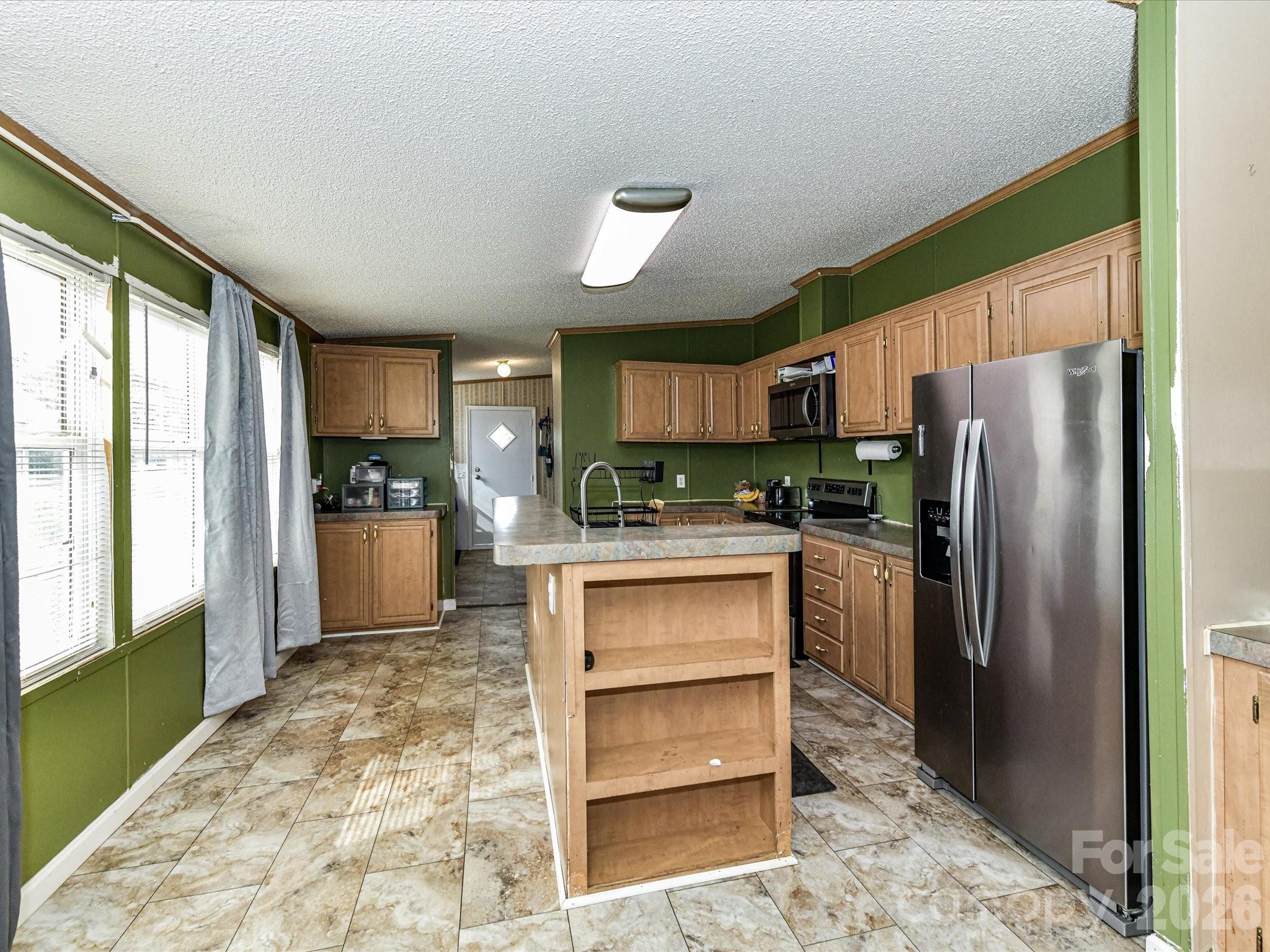 1565 Foxbrook Circle Lancaster, SC 29720 - Photo 12 of 28 a kitchen with a refrigerator sink and cabinets