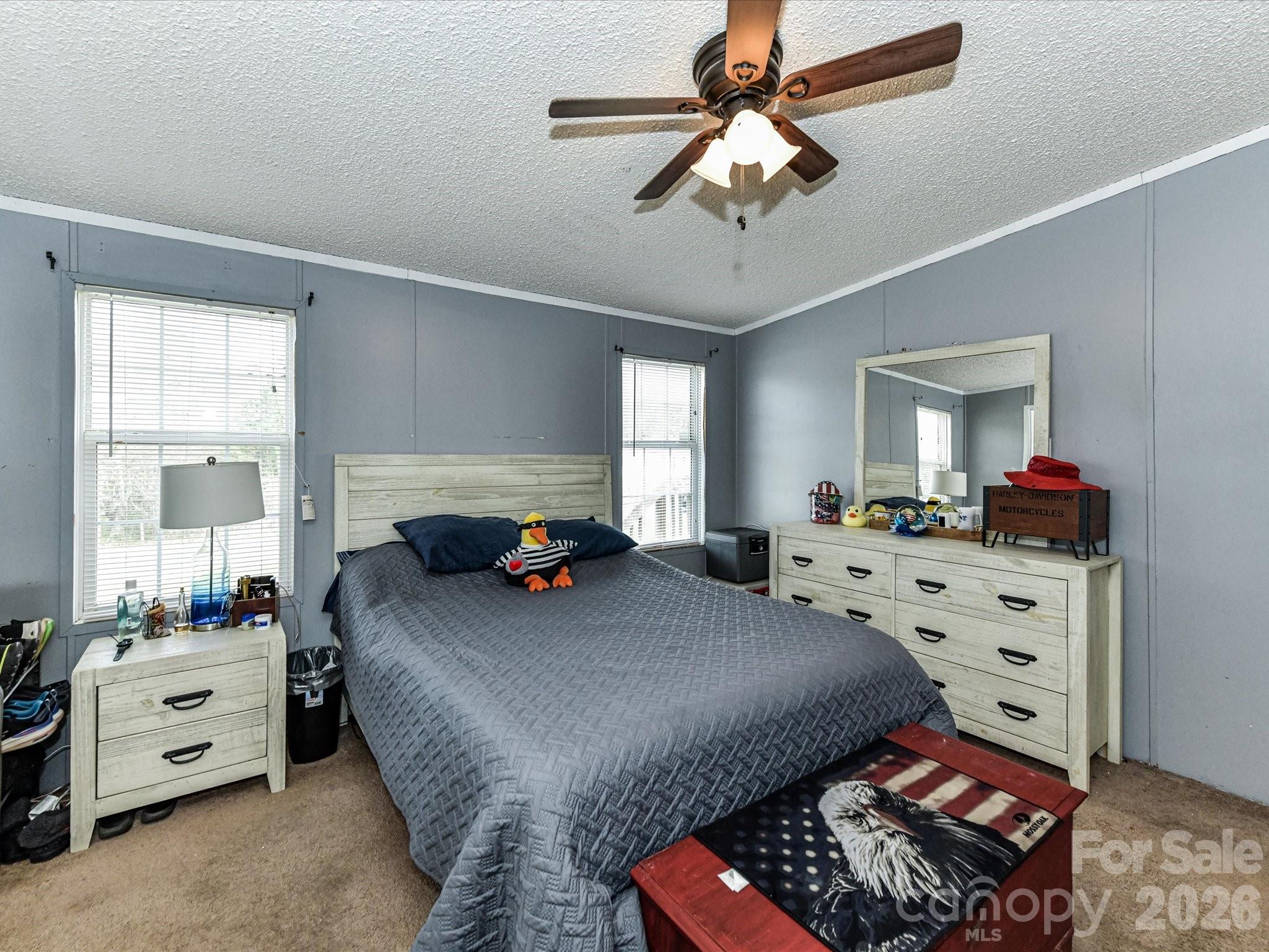 1565 Foxbrook Circle Lancaster, SC 29720 - Photo 15 of 28 a bedroom with a bed a chandelier dresser and a window