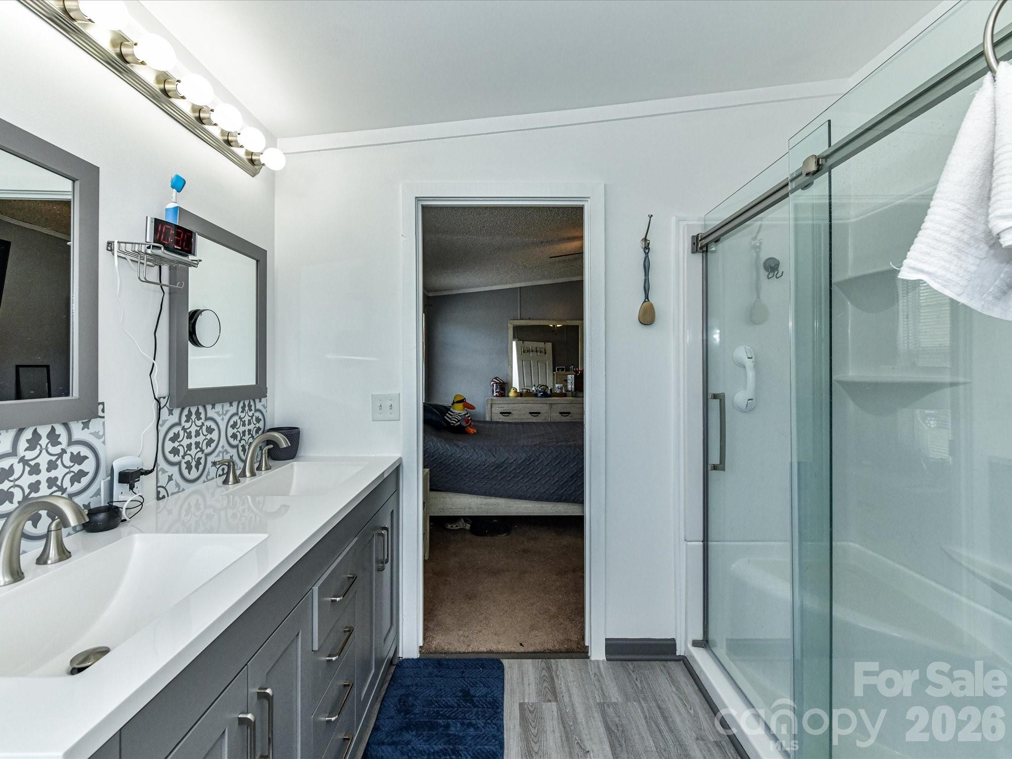 1565 Foxbrook Circle Lancaster, SC 29720 - Photo 18 of 28 a en suite bathroom with a shower sink and mirror