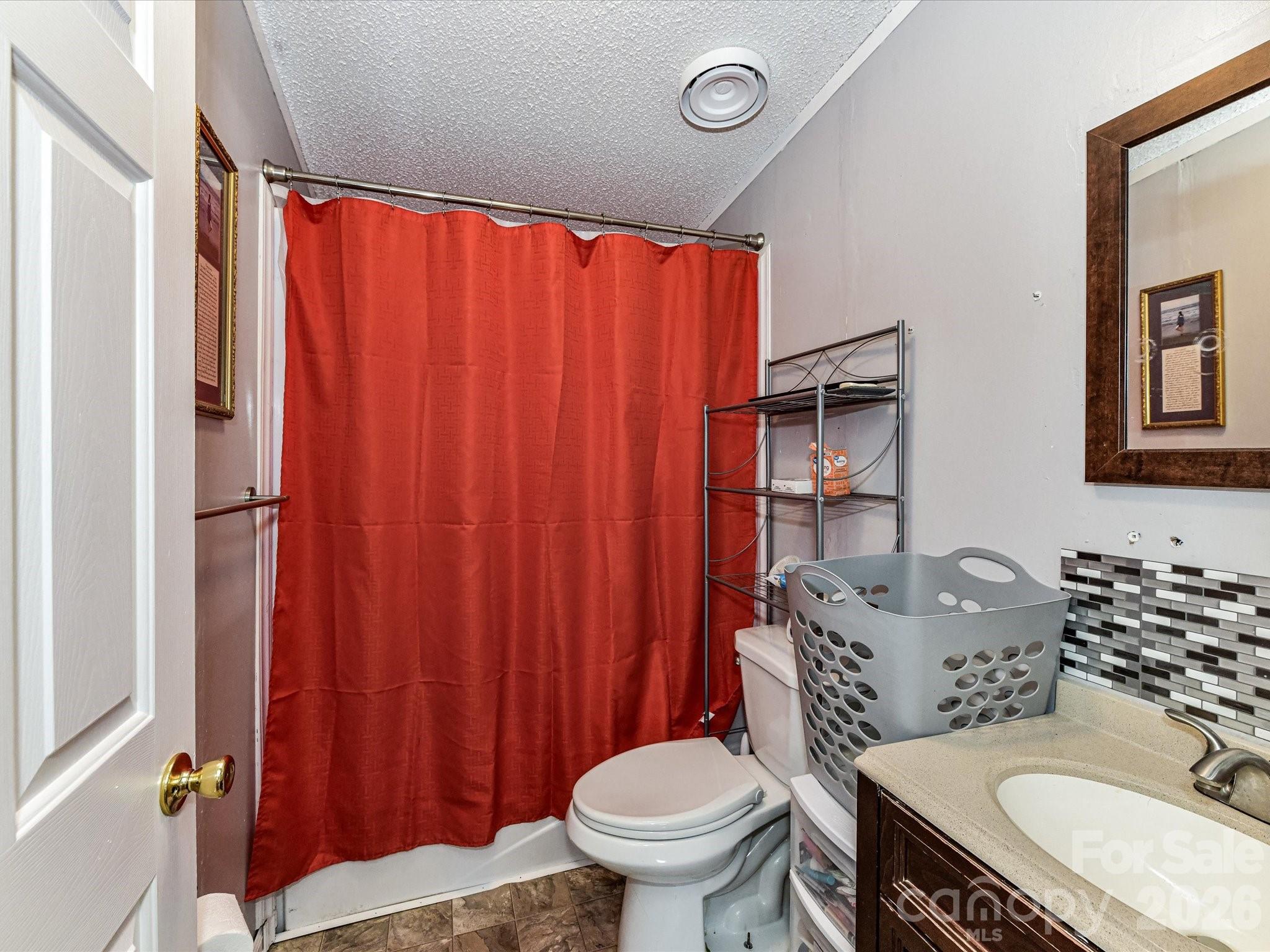 1565 Foxbrook Circle Lancaster, SC 29720 - Photo 21 of 28 a bathroom with a granite countertop sink toilet and shower curtain