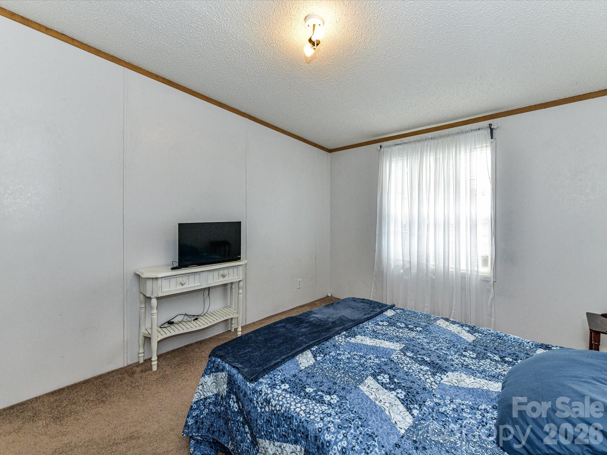 1565 Foxbrook Circle Lancaster, SC 29720 - Photo 22 of 28 a bedroom with a bed and a flat screen tv