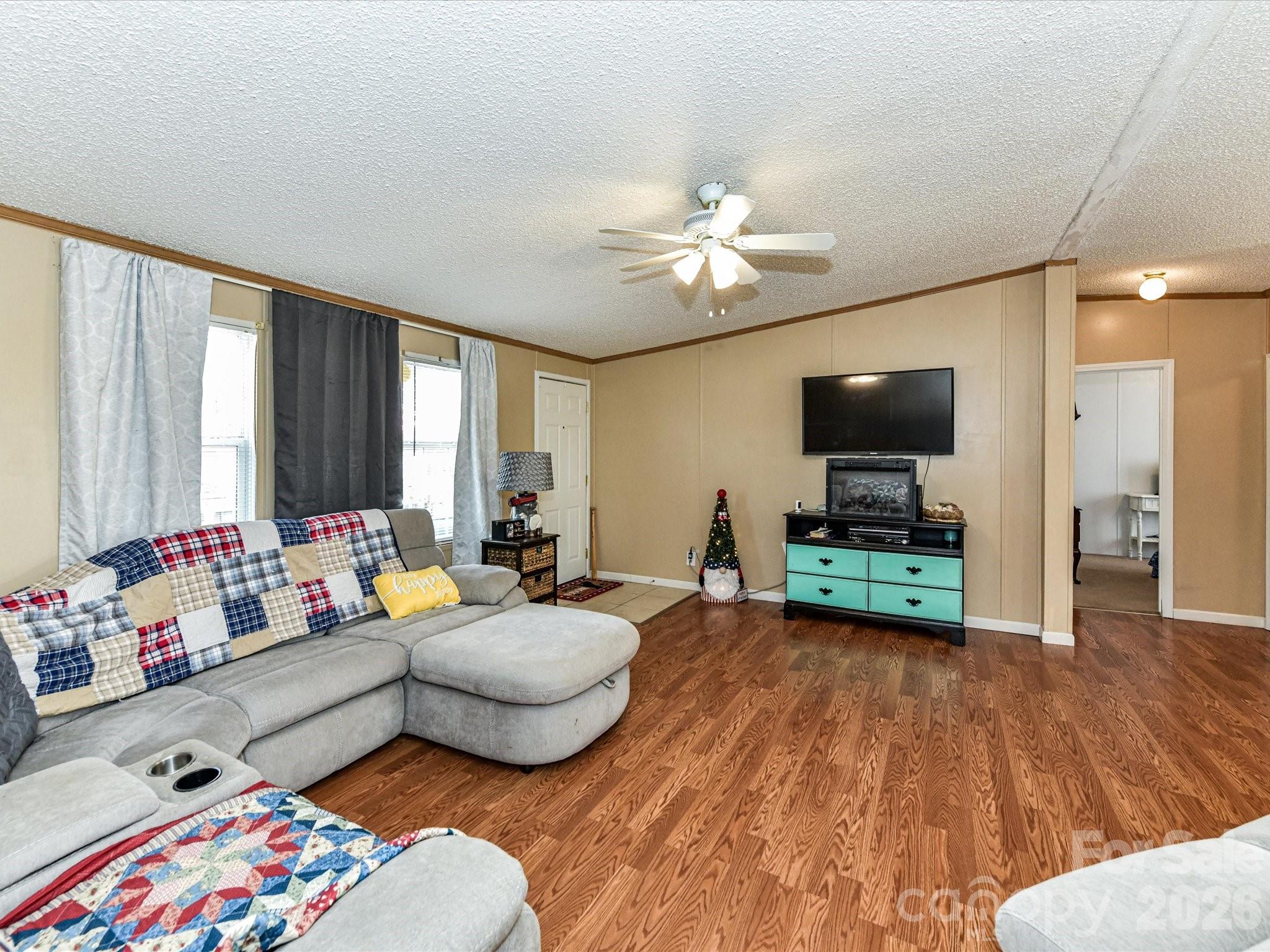 1565 Foxbrook Circle Lancaster, SC 29720 - Photo 8 of 28 a living room with furniture and a flat screen tv