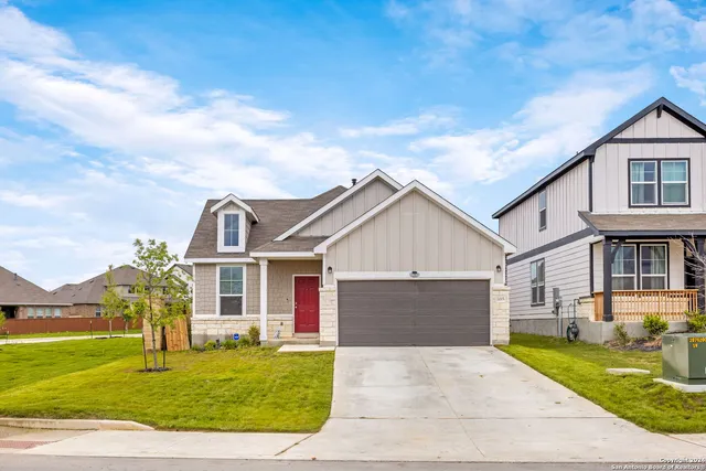 a front view of a house with a garden and yard