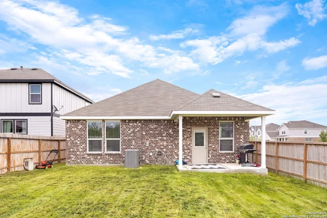 a view of a house with a large window and yard