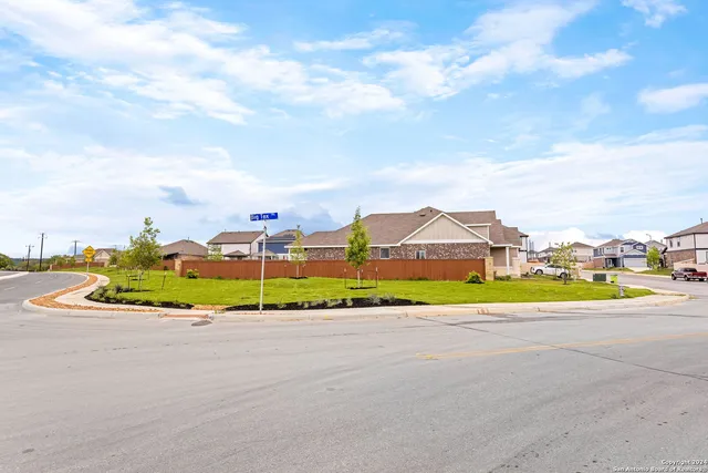 a view of an houses with a city street
