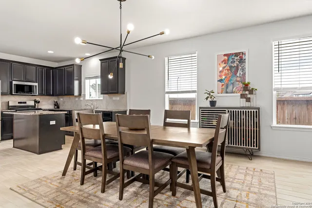 a dining room with furniture and window