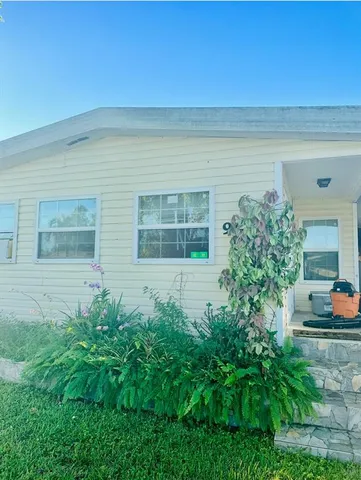 a view of front door and potted plants