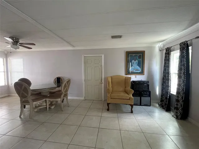 a living room with a couch and a mirror