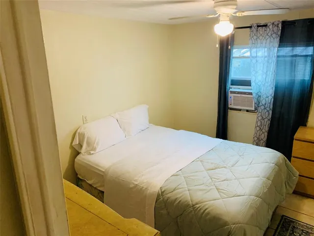 a bedroom with a bed and a mirror