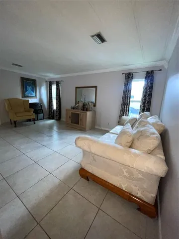 a spacious bedroom with a bed and a cabinets