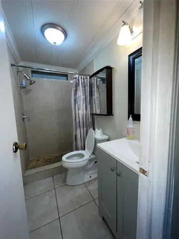 a bathroom with a toilet sink and shower