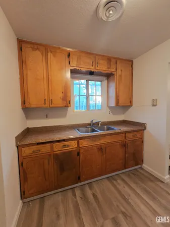 a kitchen with stainless steel appliances granite countertop a sink and cabinets