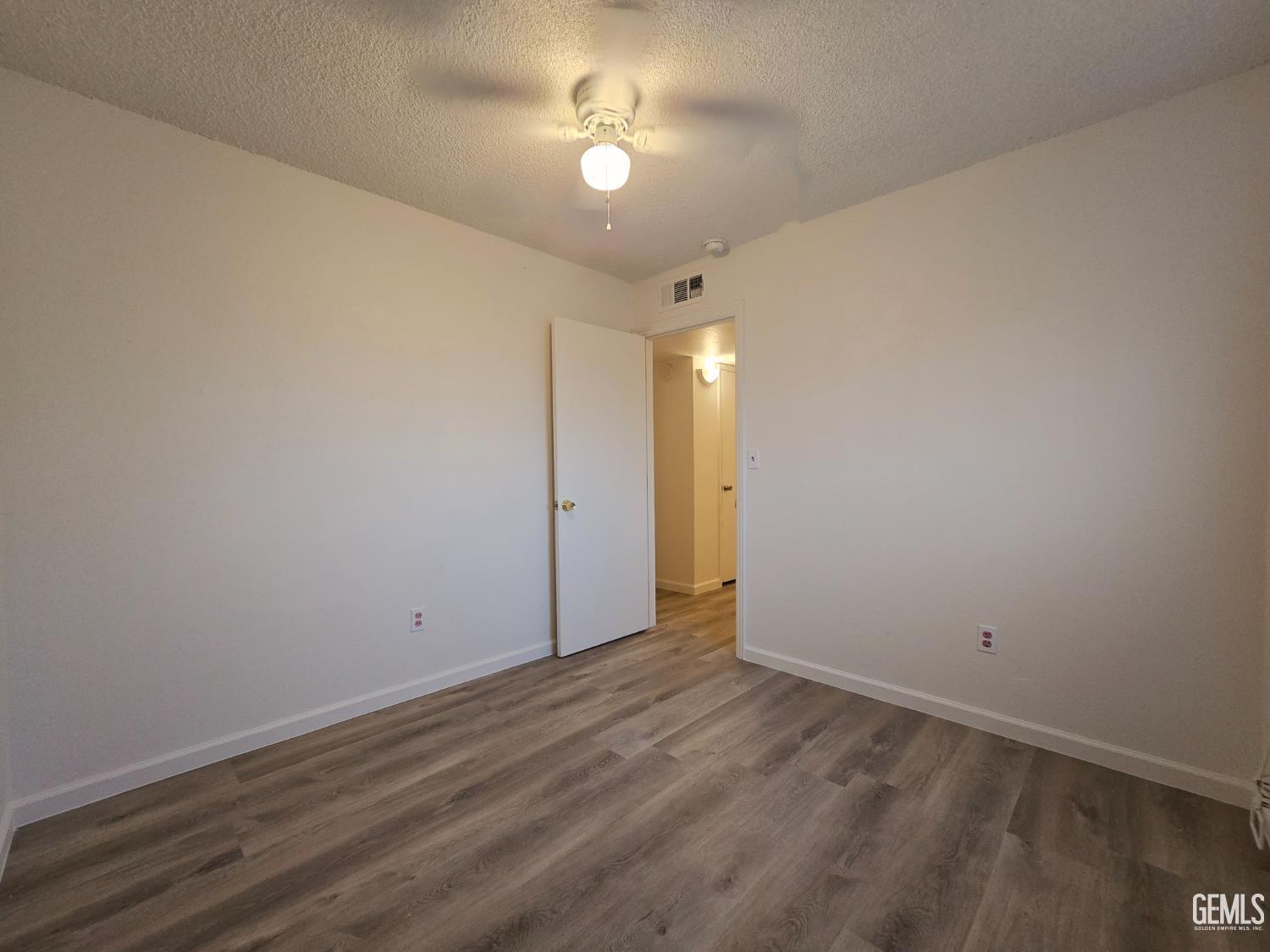 Undisclosed Address Wasco, CA 93280 - Photo 4 of 10 wooden floor in an empty room