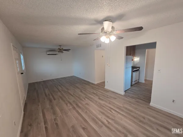 wooden floor in an empty room with a bathroom