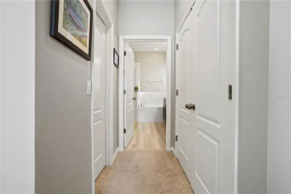 a bathroom with a granite countertop bathtub sink vanity and mirror