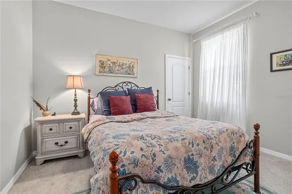 a bedroom with a bed and a chair